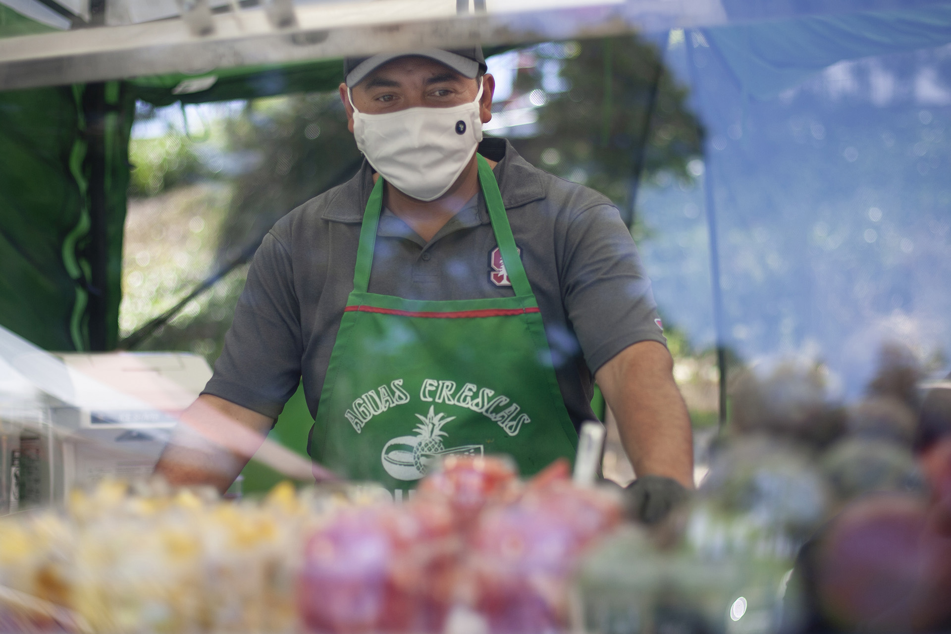 Jose Barajas works at his fresh fruit juice and smoothie stand at El Mercado farmer's market in Watsonville. Kaiser Permanente is a major sponsor of the market.