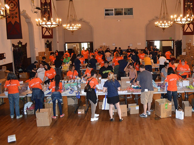 KP volunteers work with K to College to assemble thousands of dental kits for low-income students.