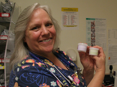 Jennell Whitney, RN, holds aromatherapy containers of lavender and peppermint.