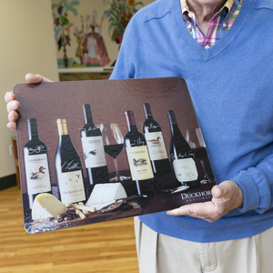 Mr. Williams provides wineries with glass cutting boards he designs through “The Third Adventure.” Recently he visited a winery where he unpacked his cutting boards, traded business cards, and signed his signature — simple tasks most take for granted but that he treasures.