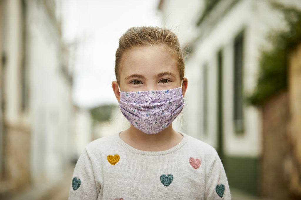 young-girl-with-hand-made-face-mask-for-covid-19-standing-on-the-street