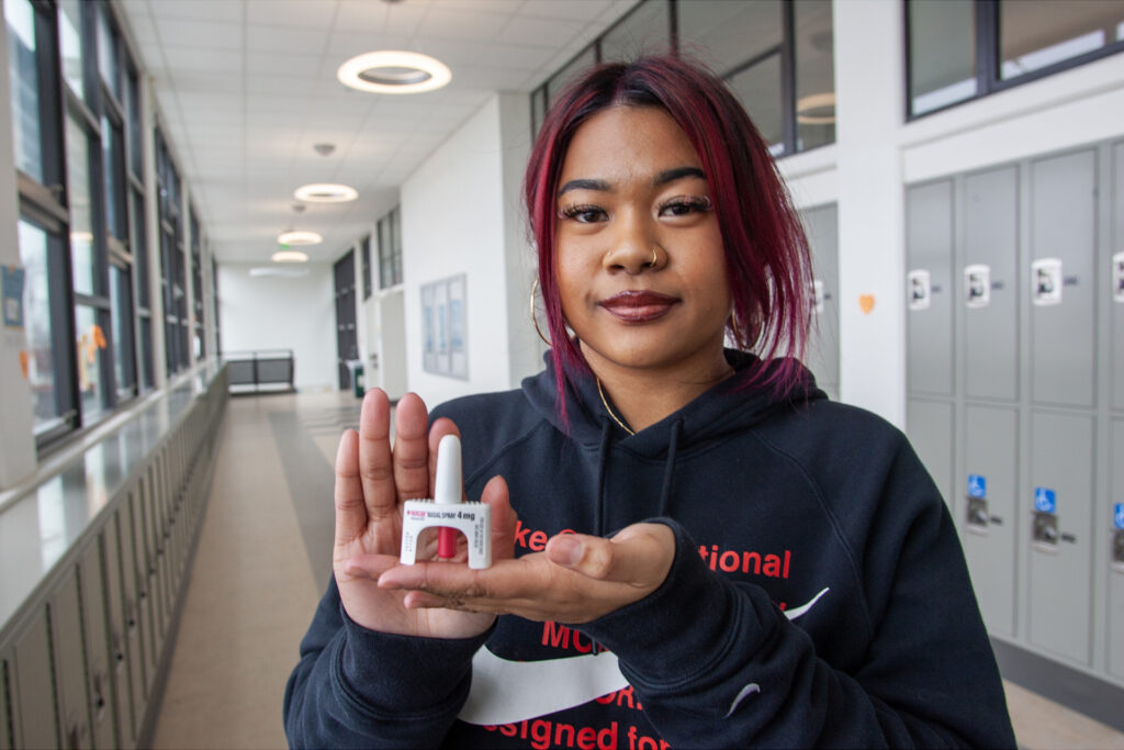 Jada Solis, a junior at Encinal High School in Alameda, California, holds a container of Narcan, which could be used to save someone from an opioid overdose.