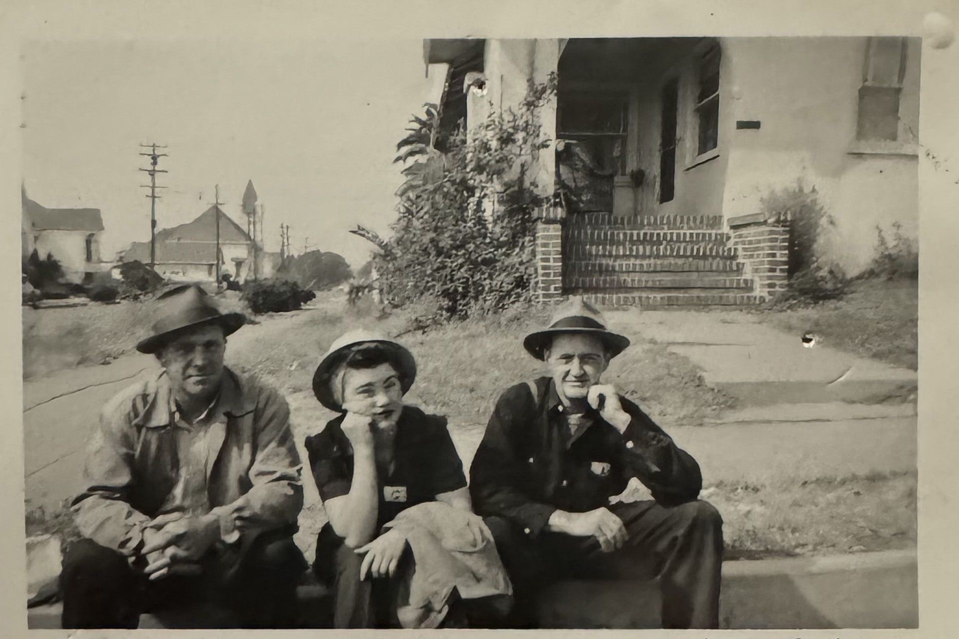 three sitting on a curb