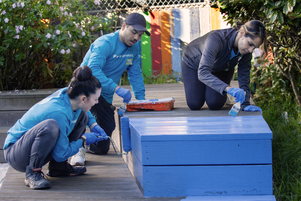 people painting a bench