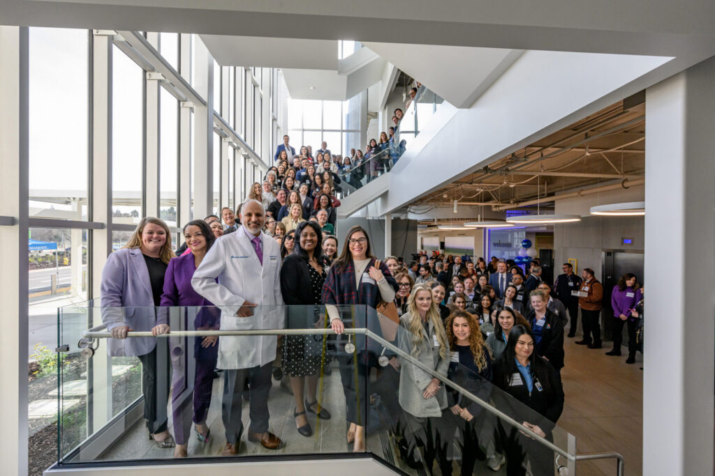 Staff gather to celebrate the opening.