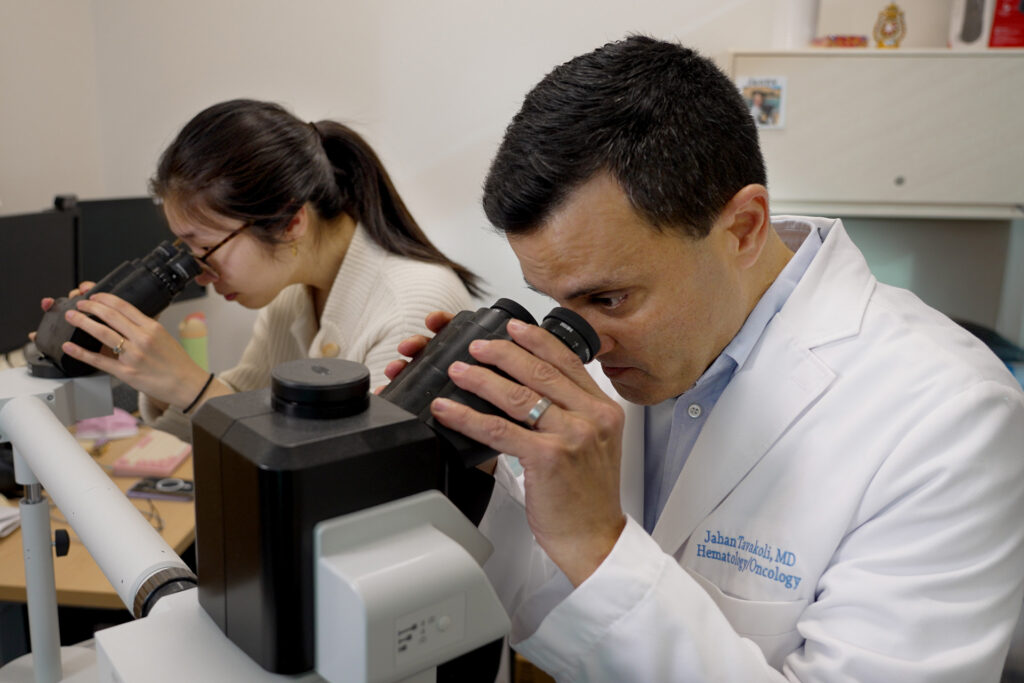 Attending Physician Jahan Tavakoly, MD, foreground, works on a research project with San Francisco Medical Center Hematology Oncology Fellow Jenny Wei, MD. 